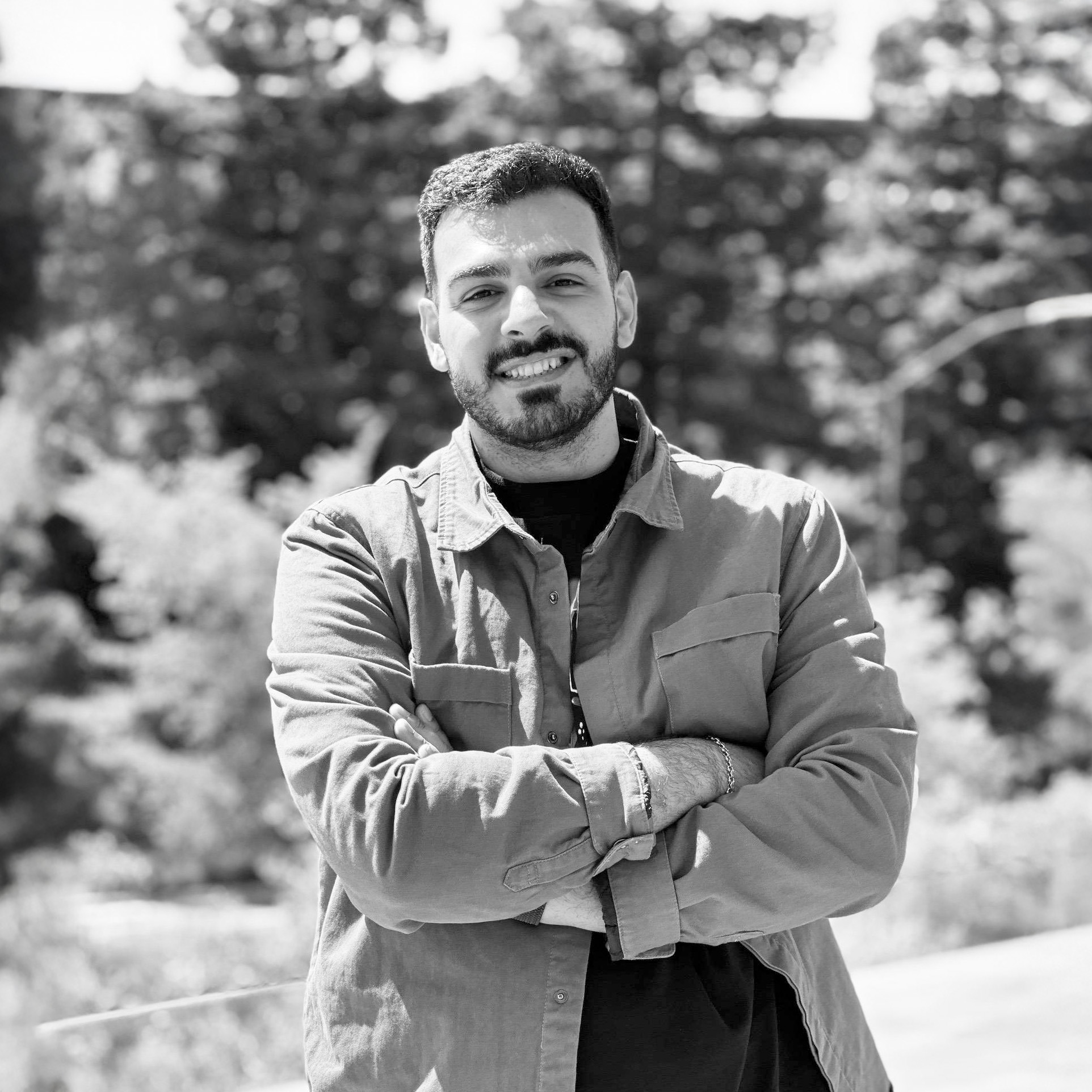 A picture if Nima Salami smiling with his arms folded